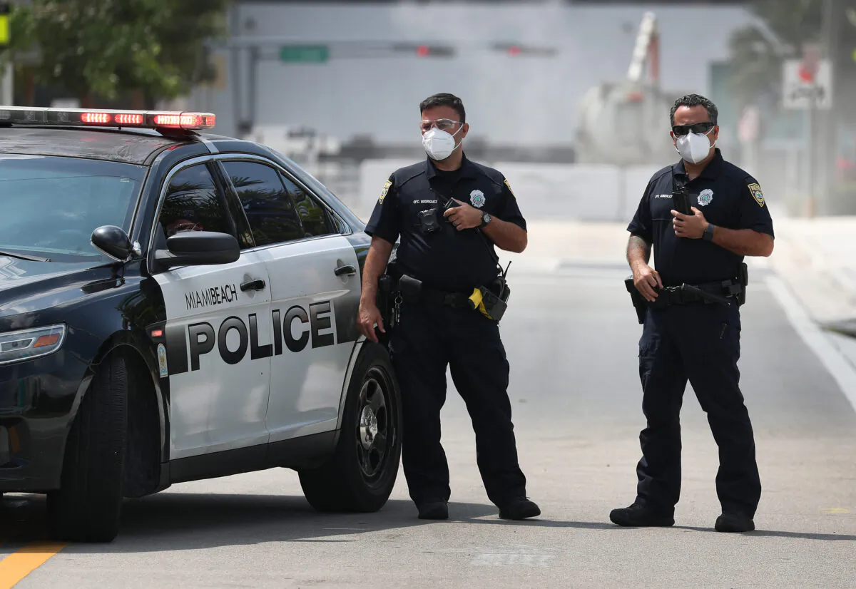 Miami Beach police officers wear protective masks outside the Miami Beach Convention Center in Miami Beach, Fla., on April 8, 2020. (Joe Raedle/Getty Images)