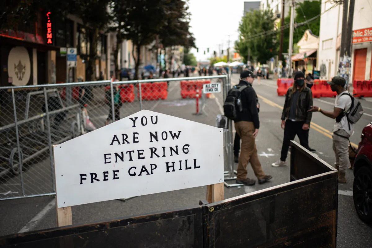 A sign on a barrier at an entrance to the so-called "Capitol Hill Autonomous Zone,” in Seattle on June 10, 2020. (David Ryder/Getty Images)