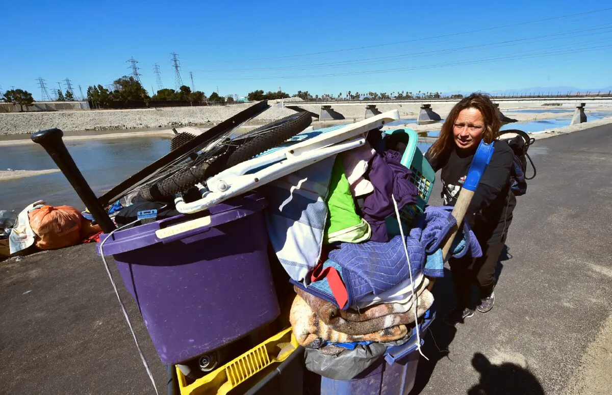 Melissa Lanning pulls her cart of belongings beside the Santa Ana River in Anaheim, Calif., on Feb. 20, 2018. (Frederic J. Brown/AFP via Getty Images)