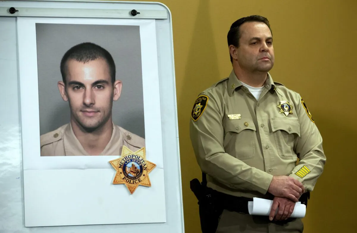 Las Vegas Police Assistant Sheriff Chris Jones stands by a photo of Metro Police officer Shay K. Mikalonis, 29, a four-year veteran of the department, during a media briefing at police headquarters in Las Vegas on June 2, 2020. (Steve Marcus/Las Vegas Sun via AP)