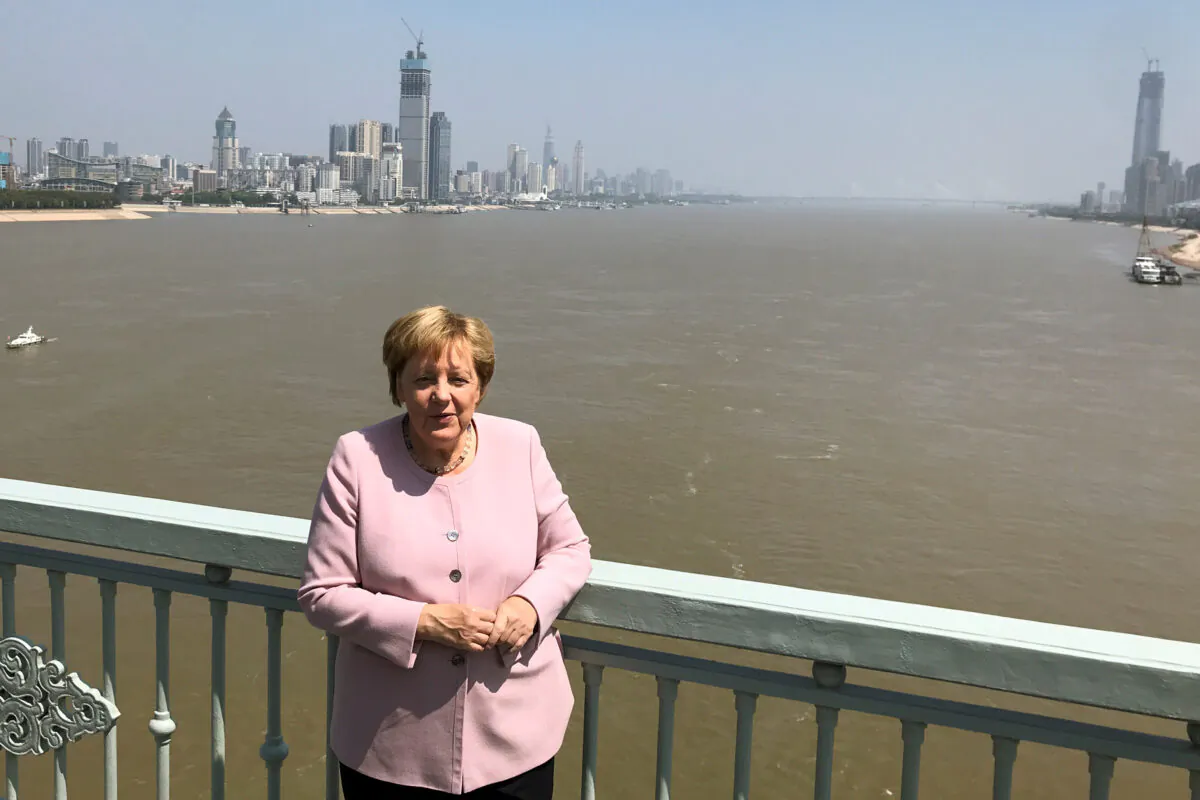 German Chancellor Angela Merkel poses for pictures on a bridge crossing the Yangtze River in Wuhan, China on Sept. 7, 2019. (Andreas Rinke/Reuters)
