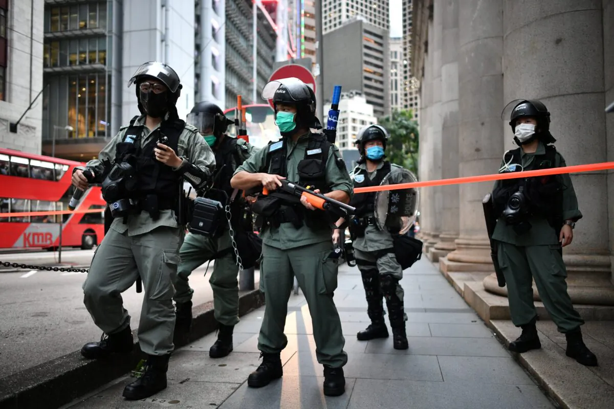 Riot police officers stand guard ahead of a pro-democracy march in the Central district of Hong Kong on June 9, 2020, as the city marks the one-year anniversary since pro-democracy protests erupted following opposition to a bill allowing extraditions to mainland China. (Anthony Wallace/AFP via Getty Images)