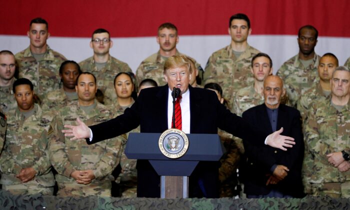 President Donald Trump delivers remarks to U.S. troops, with Afghanistan President Ashraf Ghani standing behind him, during an unannounced visit to Bagram Air Base, Afghanistan, on Nov. 28, 2019. (Tom Brenner/Reuters)