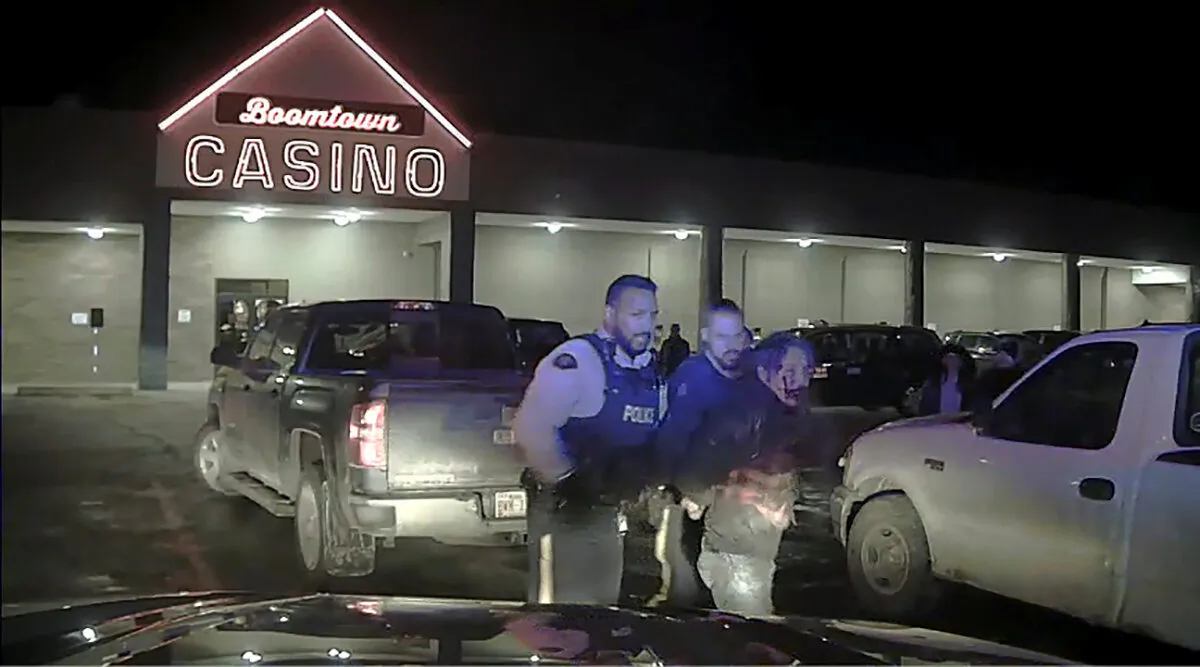 Chief Allan Adam of Athabasca Chipewyan First Nation is walked to a police vehicle during his arrest by RCMP officers in Fort McMurray on March 10, 2020, in a still from police dashcam video obtained during legal discovery. (RCMP via REUTERS)