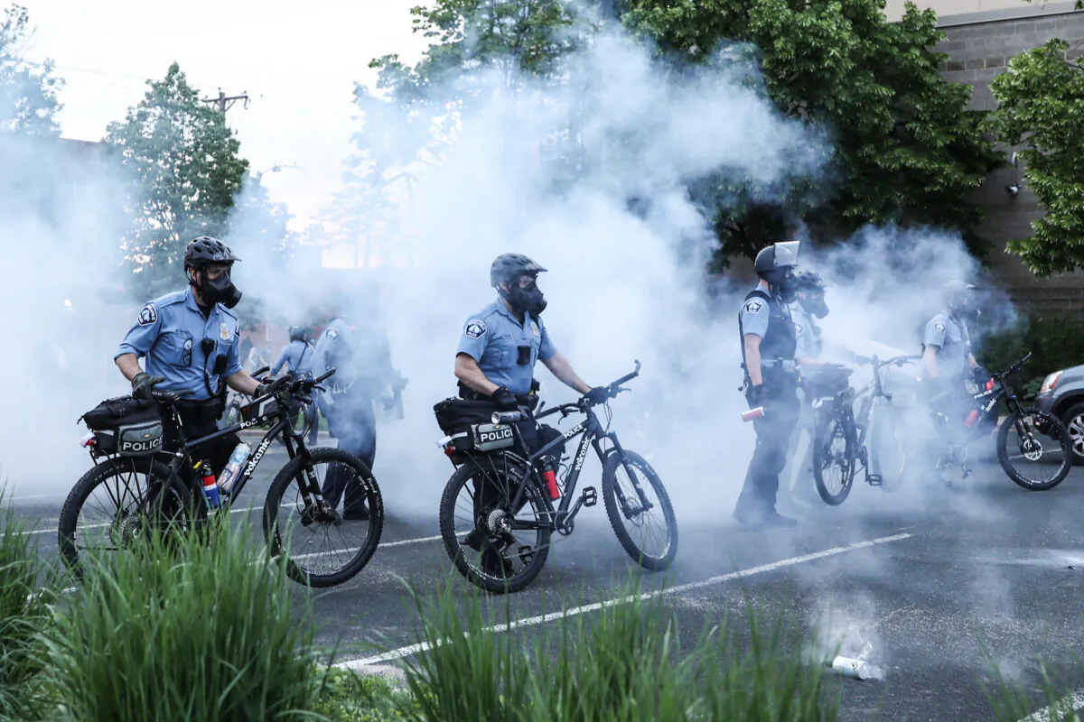 Police officers deploy tear gas and pepper spray to corral protesters before detaining them during the sixth night of protests and violence following the death of George Floyd, in Minneapolis, Minn., on May 31, 2020. (Charlotte Cuthbertson/The Epoch Times)