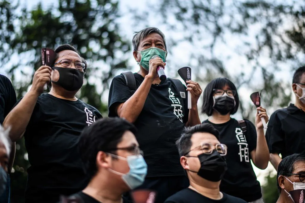 Albert Ho (top L) and Lee Cheuk-yan (top C) of the Alliance in Support of Patriotic Democratic Movements of China, speak while holding candles before entering Victoria Park in Hong Kong on June 4, 2020. (Anthony Wallace/AFP via Getty Images)