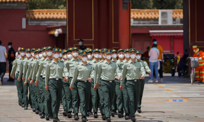 Soldiers of the People's Liberation Army march in front of the entrance of the Forbidden City in Beijing on May 20, 2020. (Andrea Verdelli/Getty Images)