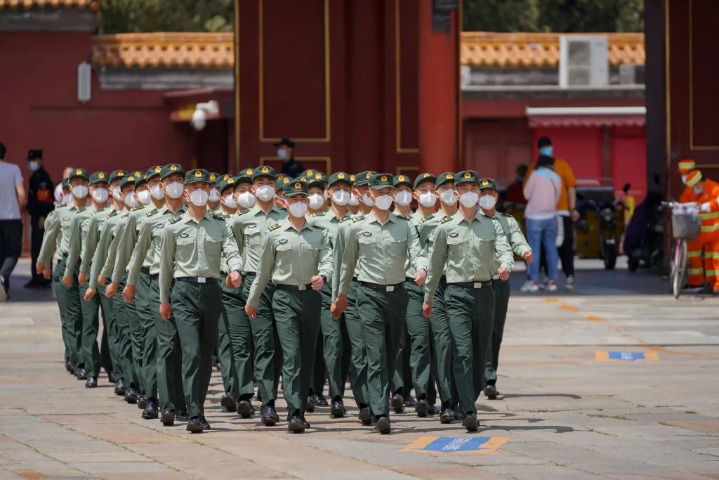 Soldiers of the People's Liberation Army march in front of the entrance of the Forbidden City in Beijing on May 20, 2020. (Andrea Verdelli/Getty Images)