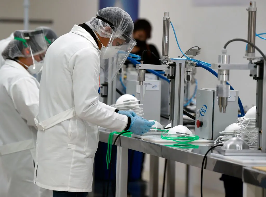 Employees work in the production of N95 face masks at a factory that produces 40,000 N95 masks per day, in Mexico City, Mexico, on May 21, 2020. (Alfredo Estrella/AFP via Getty Images)