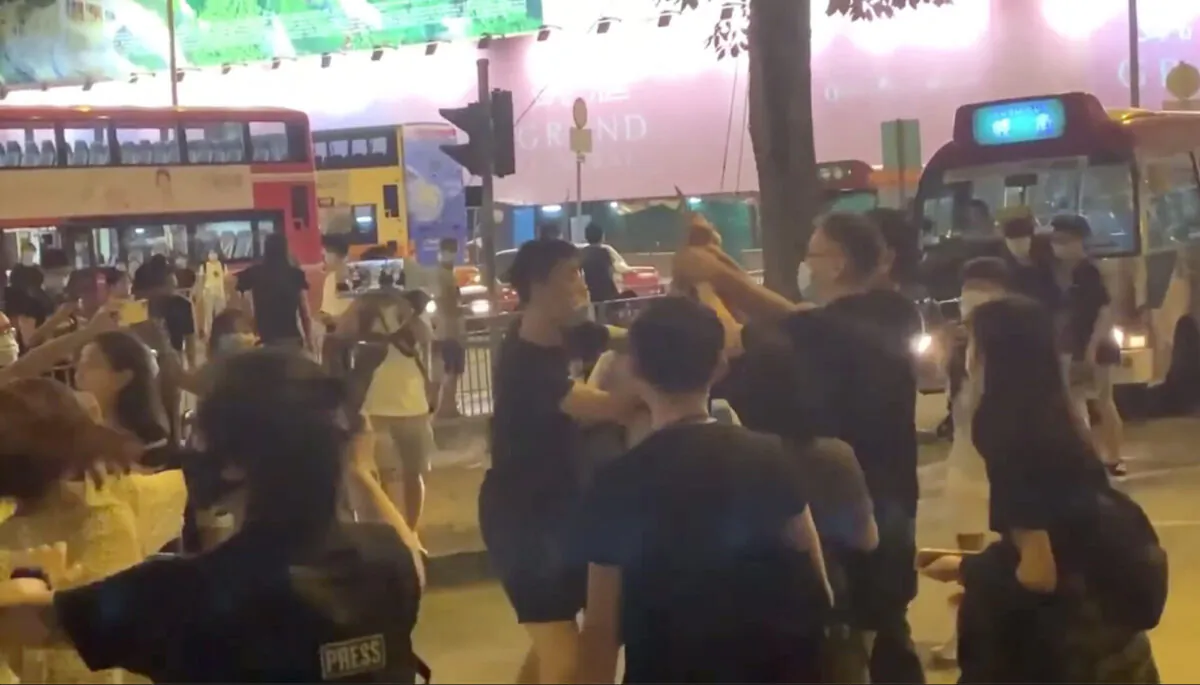 Bystanders try to subdue the knife-wielding assailant  in Kwun Tong, Hong Kong, on June 12, 2020. (Jerry/The Epoch Times)
