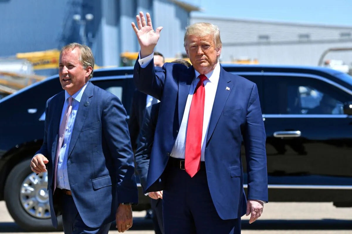 President Donald Trump gestures alongside Attorney General of Texas Ken Paxton (L) in Dallas, Texas, on June 11, 2020. (Nicholas Kamm/AFP via Getty Images)