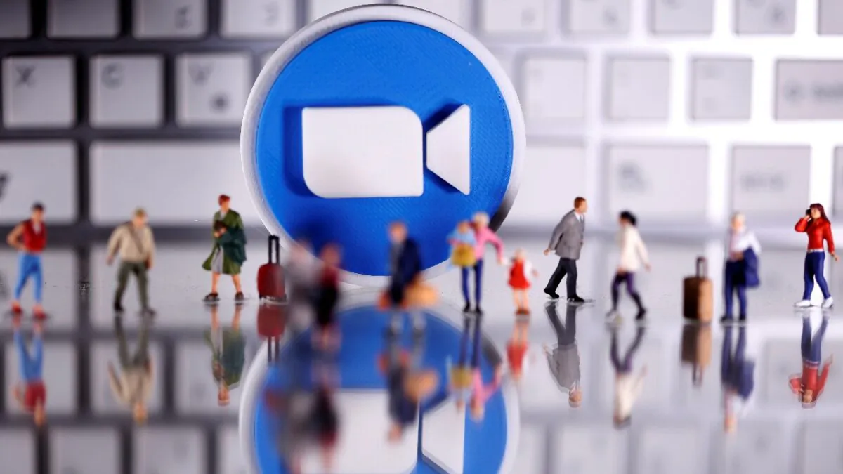 A 3D printed Zoom logo is placed between small toy people figures and a keyboard in this illustration taken on April 12, 2020. (Dado Ruvic/Reuters) 