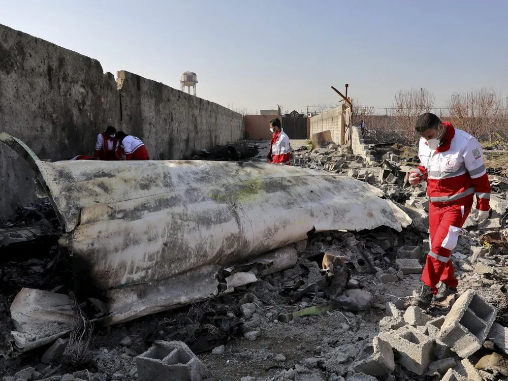 On Jan. 8, 2020, rescue workers search the scene where a Ukrainian plane crashed in Shahedshahr, southwest of the capital Tehran, Iran. (Ebrahim Noroozi/THE ASSOCIATED PRESS)