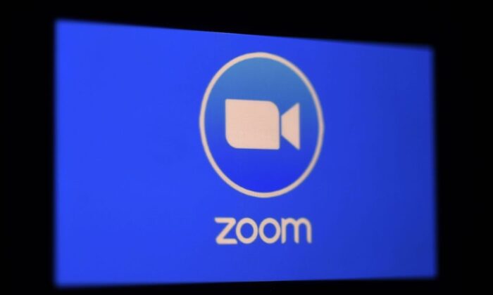 A Zoom App logo is displayed on a smartphone. (Olivier Douliery/AFP via Getty Images)