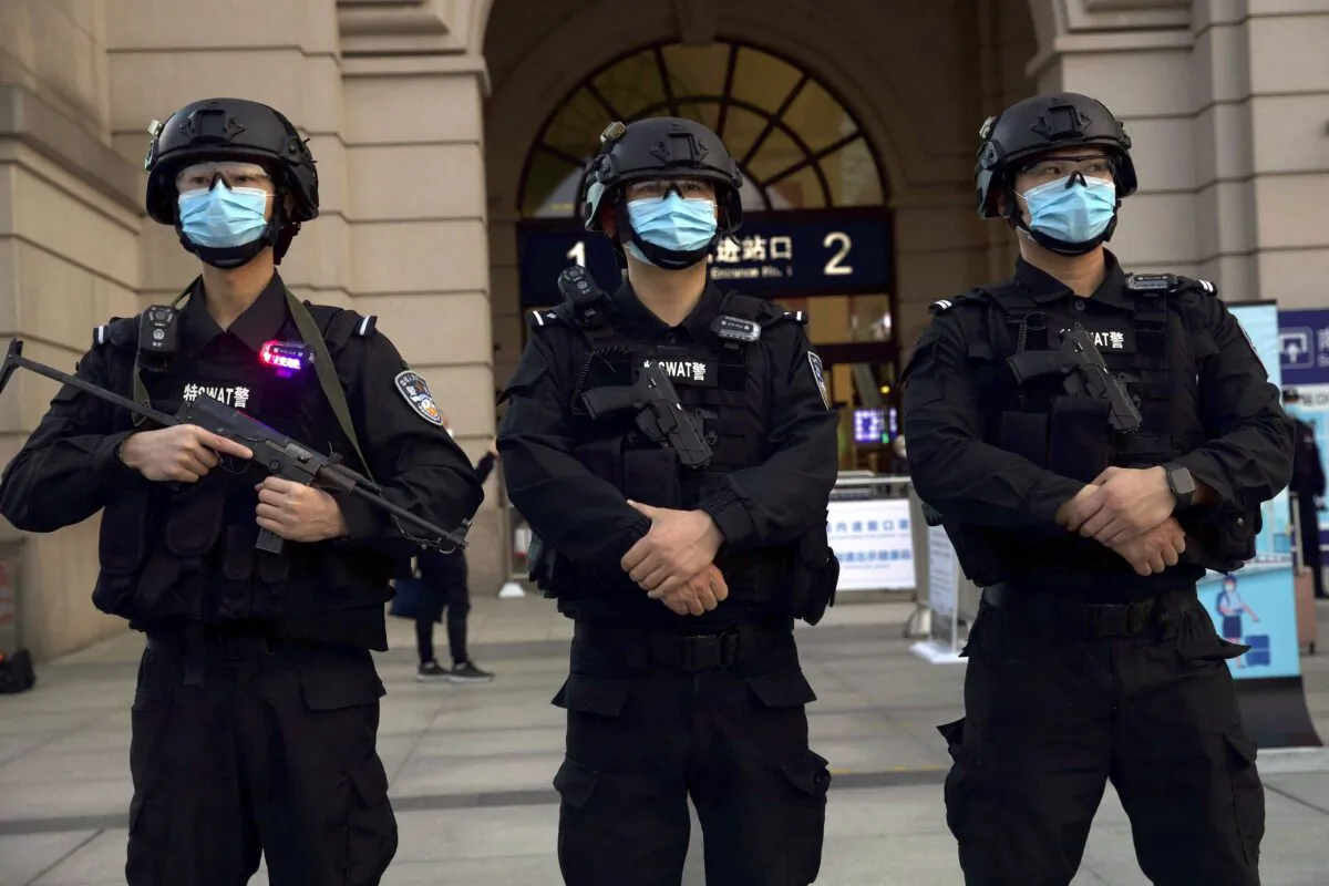 Police officers stand guard outside Hankou Railway Station ahead of the resumption of train services in Wuhan on April 8, 2020. Holding Beijing to account for its coverup of the virus outbreak was one of the topics for discussion at a recent online forum titled “China at a Crossroads: Standing Up for Human Rights During the Pandemic.” (AP Photo/Ng Han Guan)