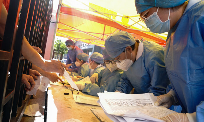 Medical workers sort nucleic acid test results for the citizens at a hospital in Beijing on June 14, 2020. (Lintao Zhang/Getty Images)