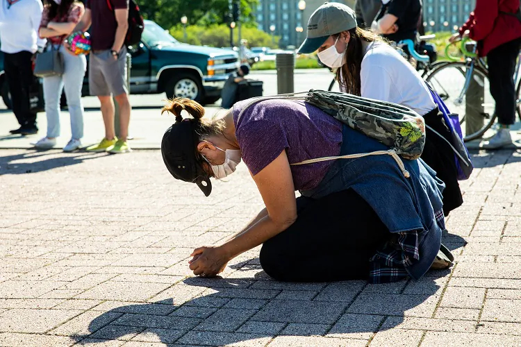 A protester kneels in Chicago on June 13, 2020. (Natasha Moustache/Getty Images)