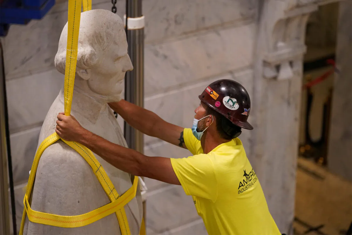Artifacts were found inside of the base of the Jefferson Davis statue during its removal Saturday. (Reuters)