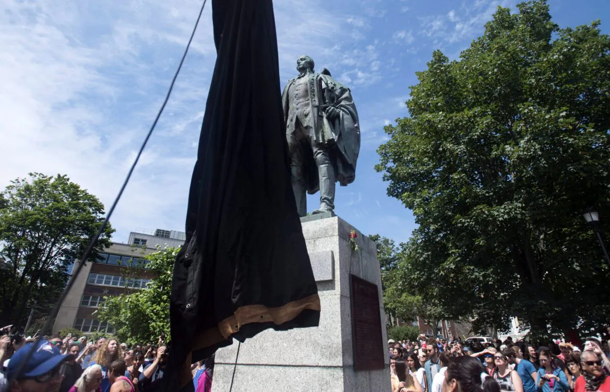 The statue of Edward Cornwallis, the founder of Halifax, is about to be covered as activists protest in Cornwallis Park in Halifax on July 15, 2017. The statue was removed on Jan. 31, 2018. (The Canadian Press/Darren Calabrese)