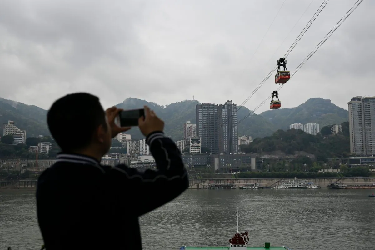 A man taking photos in Chongqing city, southwestern China, on March 22, 2019. (WANG ZHAO/AFP via Getty Images)