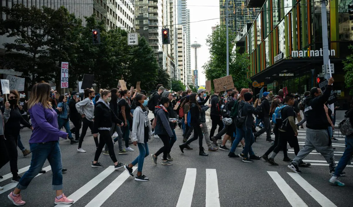 Black Lives Matter protesters march through a downtown street in Seattle, Wash., on June 14, 2020. (David Ryder/Getty Images)