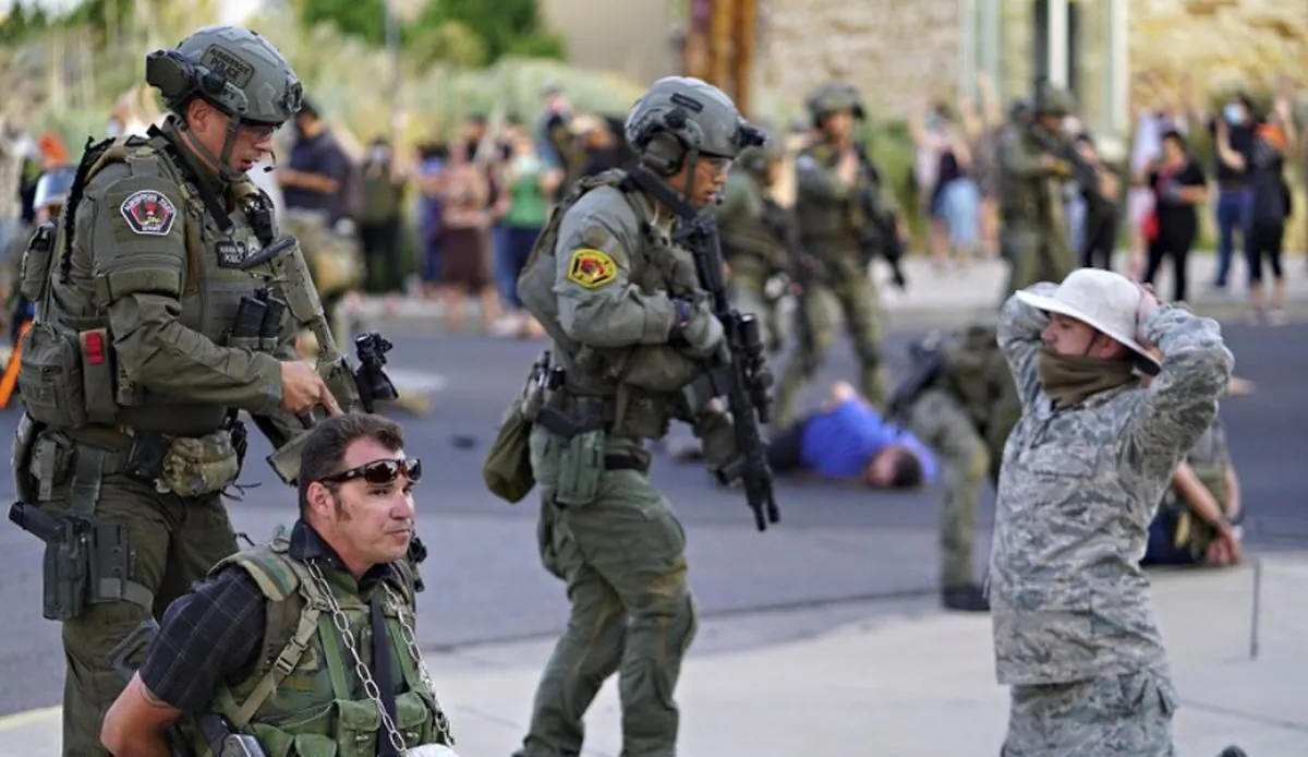 Albuquerque police detain members of the New Mexico Civil Guard, an armed civilian group, following the shooting of a man during a protest over a statue of Spanish conquerer Juan de Oñate in Albuquerque, N.M. on June 15, 2020. (Adolphe Pierre-Louis/The Albuquerque Journal via AP)