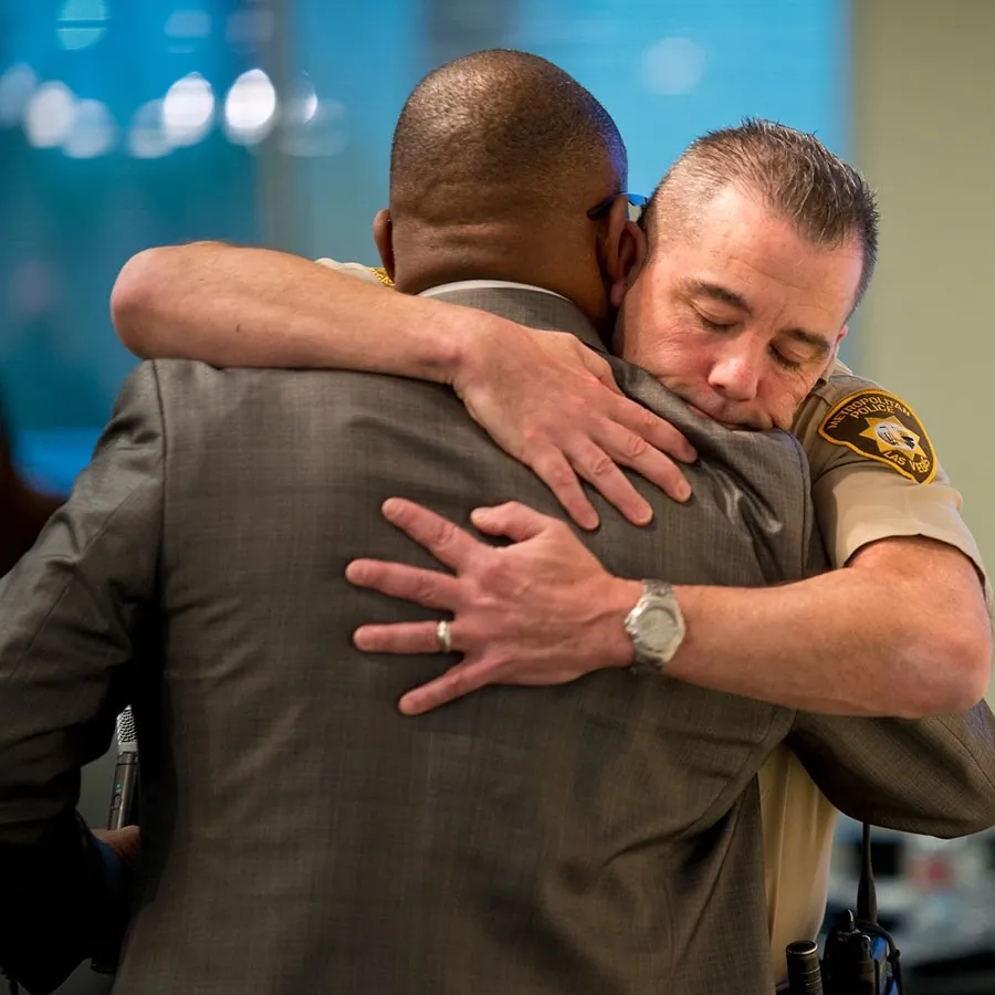 Jon Ponder, founder of HOPE for Prisoners, embraces a Las Vegas police officer. (Courtesy of Jon Ponder)