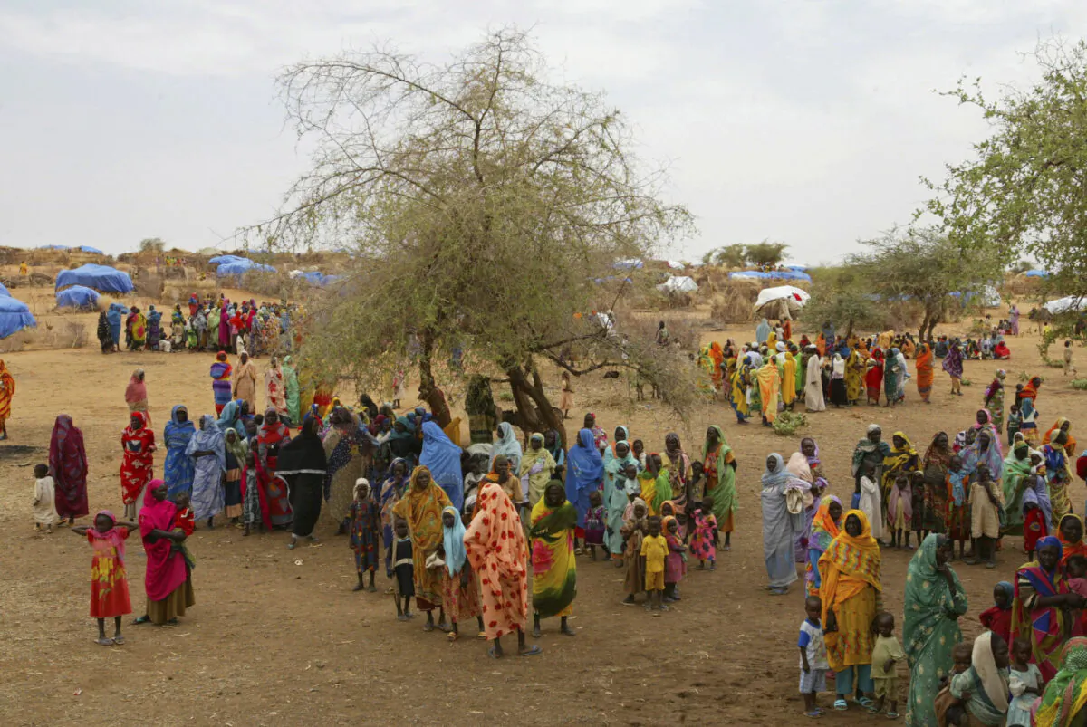 Sudanese displaced women gather at the Zam Zam refugee camp just outside the town of El-Fashir in the Darfour region of Sudan, during a visit by U.N. Secretary General Kofi Annan. (Karel Prinsloo, File/AP)