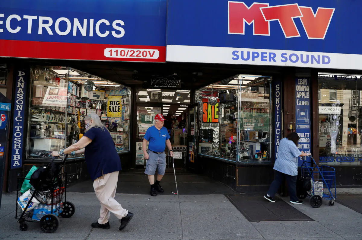 Shoppers are seen outside a retail store as the phase one reopening of New York City continues during the outbreak of the CCP virus in the Brooklyn borough of New York City on June 9, 2020. (Shannon Stapleton/Reuters)