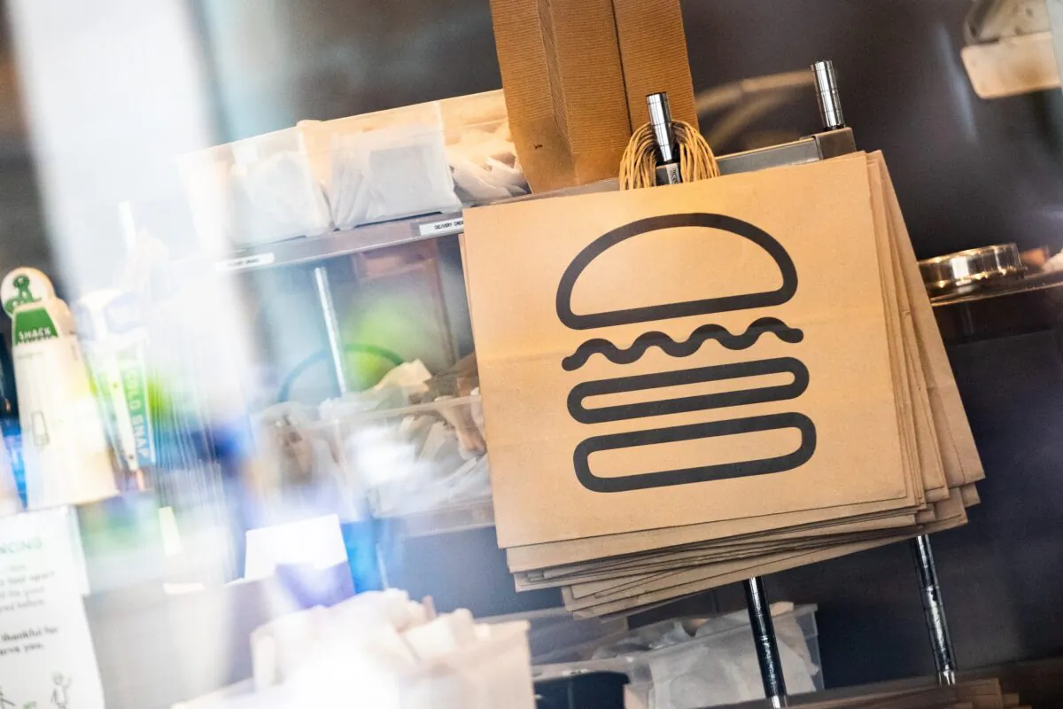 Shake Shack paper bags hang at a restaurant in New York City, N.Y., on April 20, 2020.  (Jeenah Moon/Getty Images)
