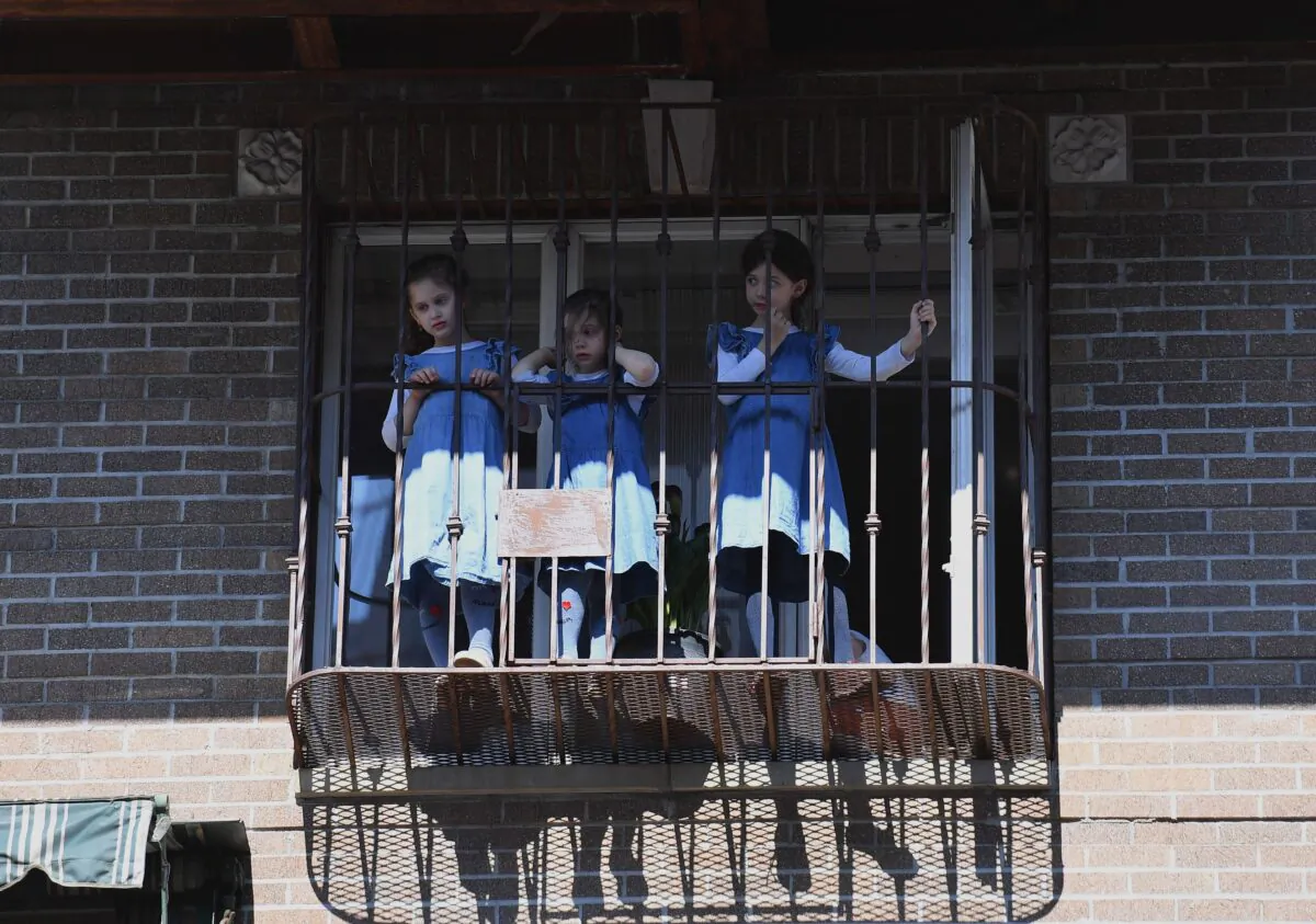 Orthodox Jewish girls watch from their windows as protesters walk through the Brooklyn borough on June 3, 2020, during a "Breonna Taylor and Black Lives Matter" protest in New York City. (Angela Weiss/AFP via Getty Images)