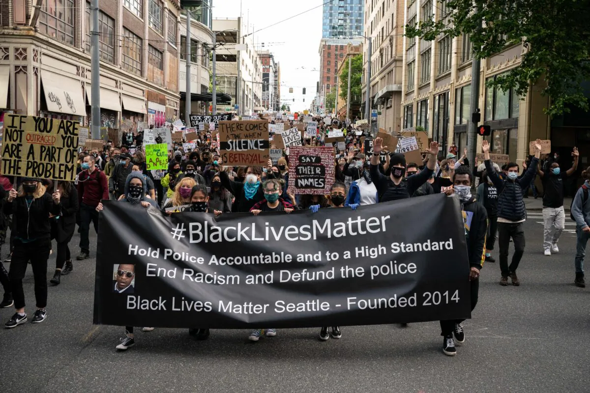 Black Lives Matter protesters march through a downtown street in Seattle on June 14, 2020. (David Ryder/Getty Images)