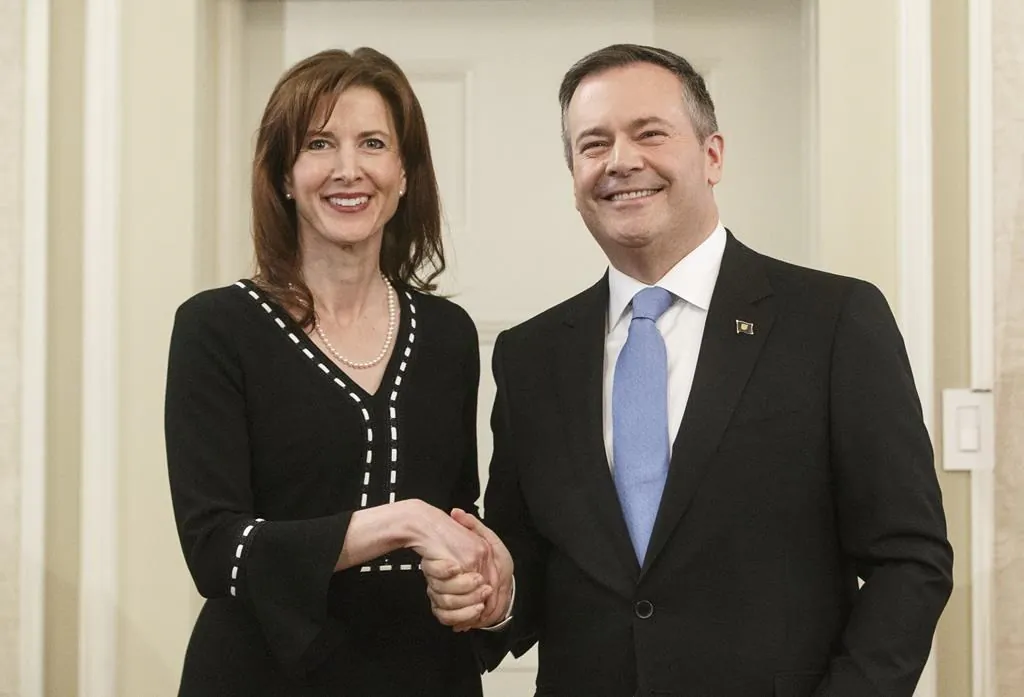 Alberta Premier Jason Kenney shakes hands with Tanya Fir, associate minister of red tape reduction, in Edmonton on April 30, 2019. (Jason Franson/The Canadian Press)