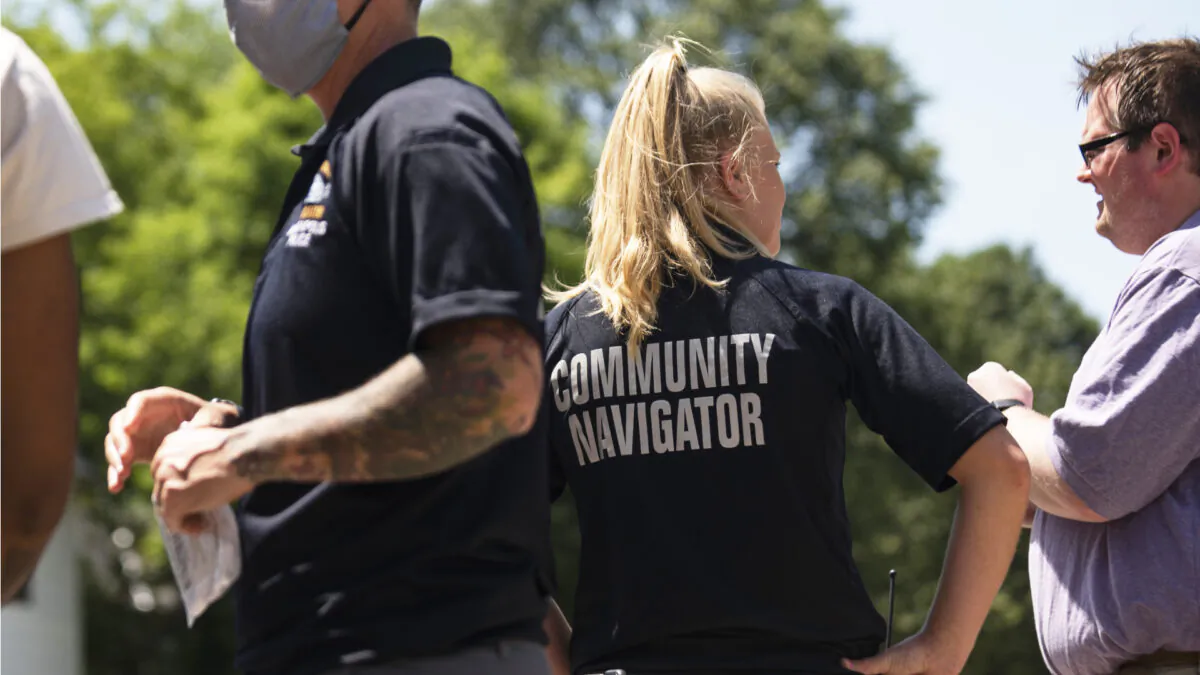 Members of the Minneapolis Police Department Community Navigator program speak with people gathered near a crime scene in Minneapolis, Minn., on June 16, 2020. (Stephen Maturen/Getty Images)