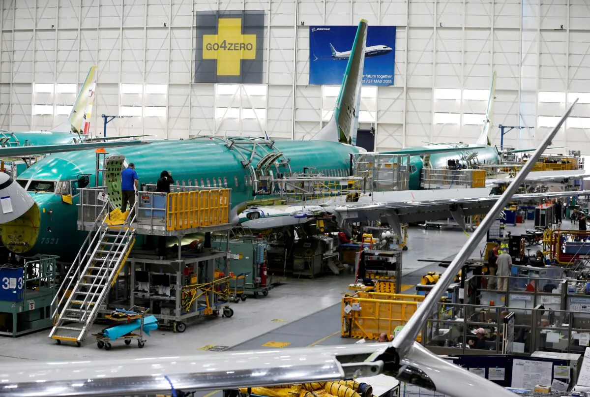Technicians work near the door of a 737 Max aircraft at the Boeing factory in Renton, Wash., on March 27, 2019. (Lindsey Wasson/Reuters)
