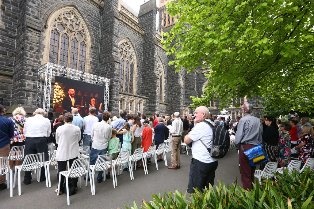 Mourners watch a telecast outside St Patrick's Cathedral during the state funeral for Sisto Malaspina on November 20, 2018 in Melbourne, Australia.  Sisto Malaspina was killed by a lone terrorist. (Michael Dodge - Pool/Getty Images)
