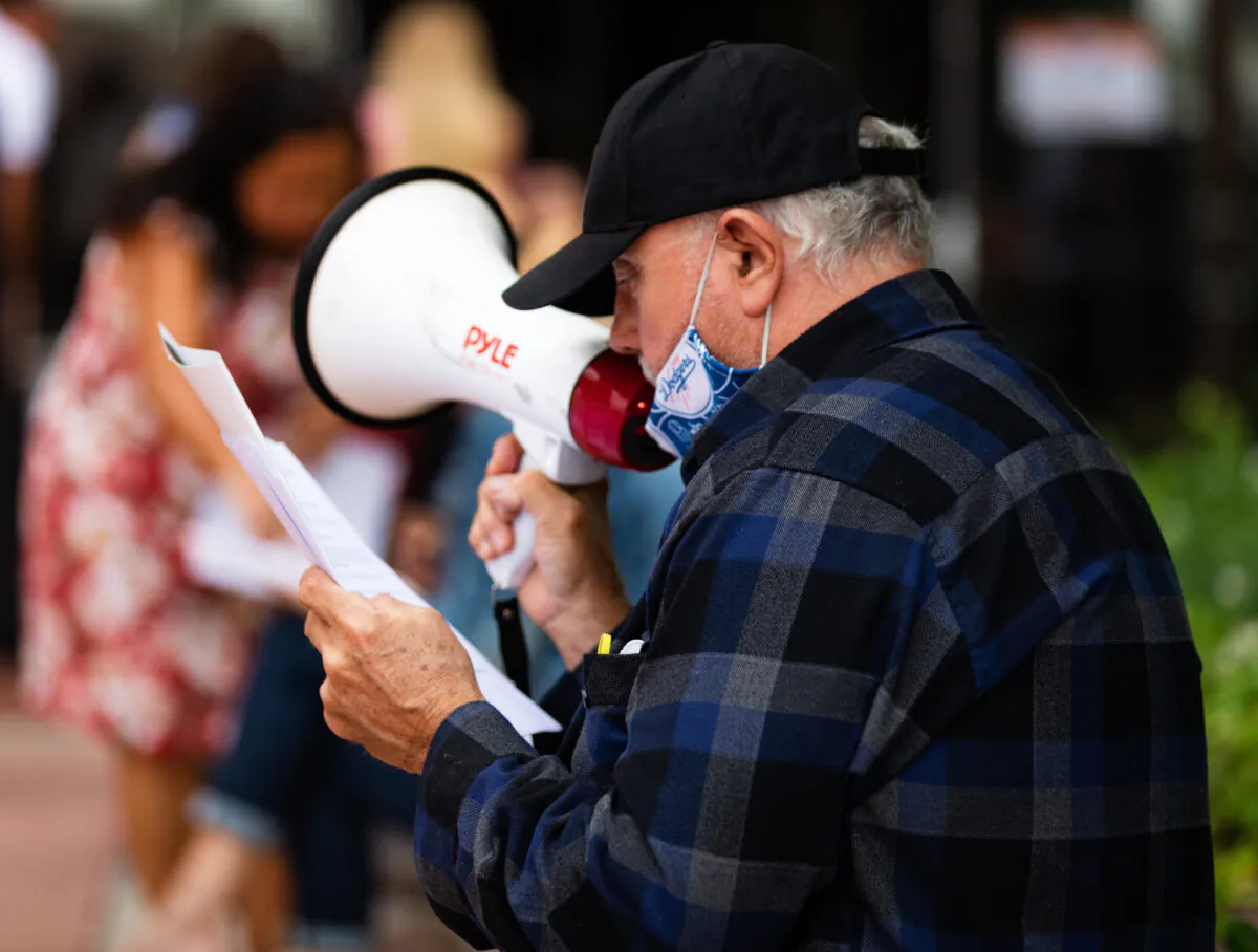 A protester uses a bullhorn in Santa Ana, Calif., on June 16, 2020. (John Fredricks/The Epoch Times)
