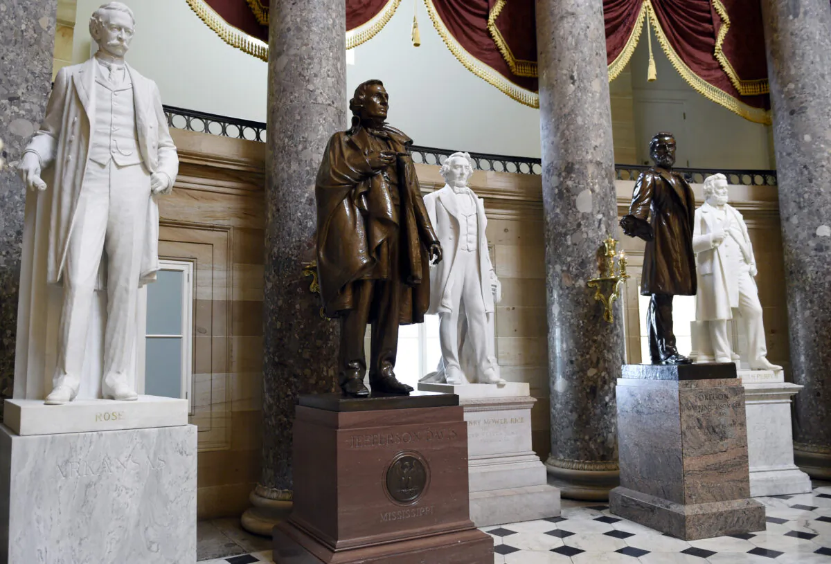 In this June 24, 2015 file photo, a statue of Jefferson Davis, second from left, president of the Confederate States from 1861 to 1865, is on display in Statuary Hall on Capitol Hill in Washington. House Speaker Nancy Pelosi is demanding that statues of Confederate figures such as Jefferson Davis be removed from the U.S. Capitol. (Susan Walsh/AP Photo)