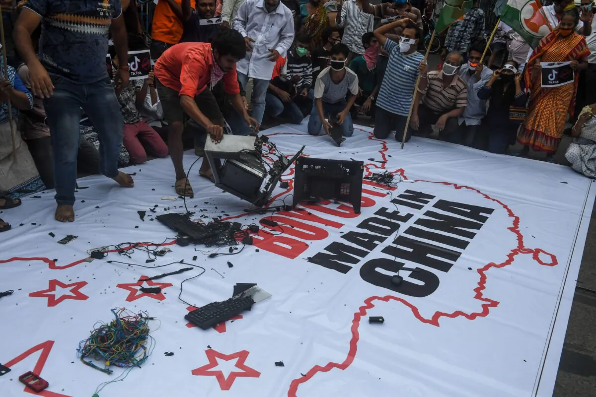 Indian congress party supporters leave Chinese goods on a flag displaying the country of China, along with an inscription reading 'Boycott Made in China,' during an anti-China demonstration in Kolkata, India on June 18, 2020. (DIBYANGSHU SARKAR/AFP via Getty Images)