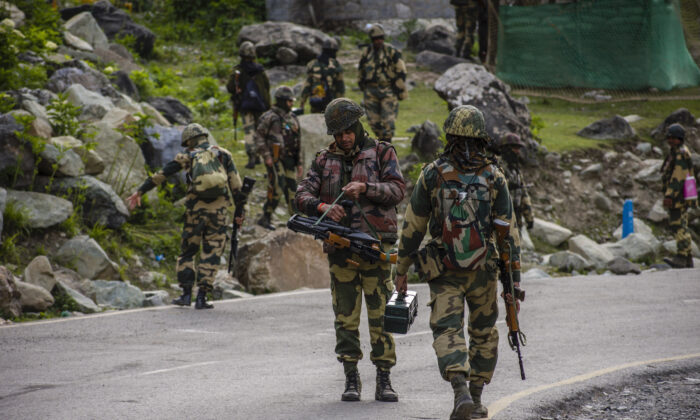 Indian Border Security Force (BSF) soldiers patrol a highway leading towards Leh, bordering China, in Gagangir, India, on June 19, 2020. (Yawar Nazir/Getty Images)