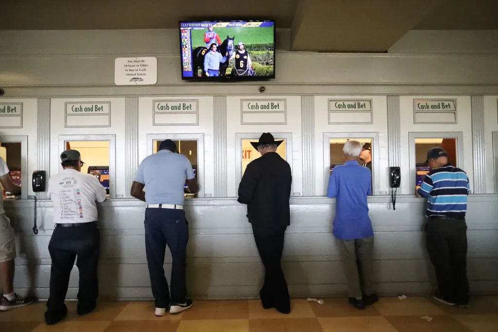Gamblers stand at betting windows on the final day of the winter/spring horse racing season at Santa Anita Park in Arcadia, Calif., on June 23, 2019. (Mario Tama/Getty Images)