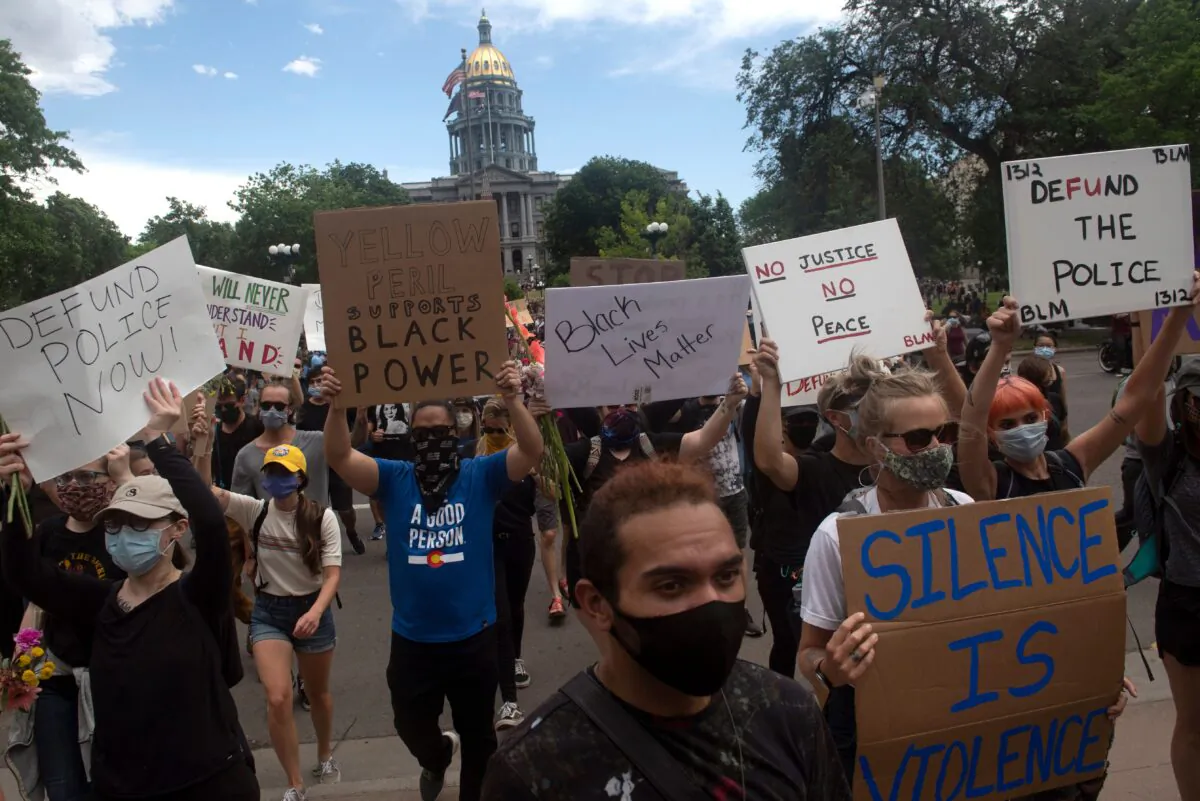 Protesters march during a demonstration over the death of George Floyd, in Denver, Colo., on June 6, 2020. (Jason Connolly/AFP via Getty Images)