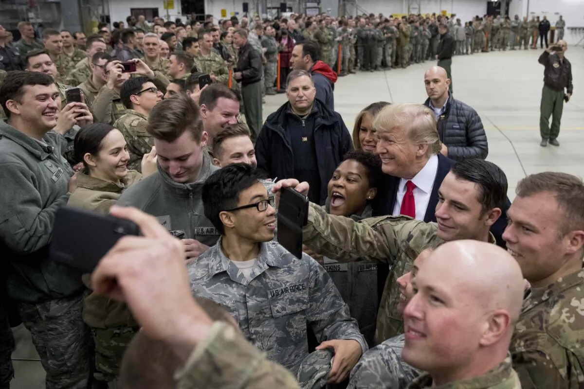 President Donald Trump, center right, and first lady Melania Trump, center left, greet members of the military at Ramstein Air Base, Germany, on Dec. 27, 2018. (Andrew Harnik/AP Photo)