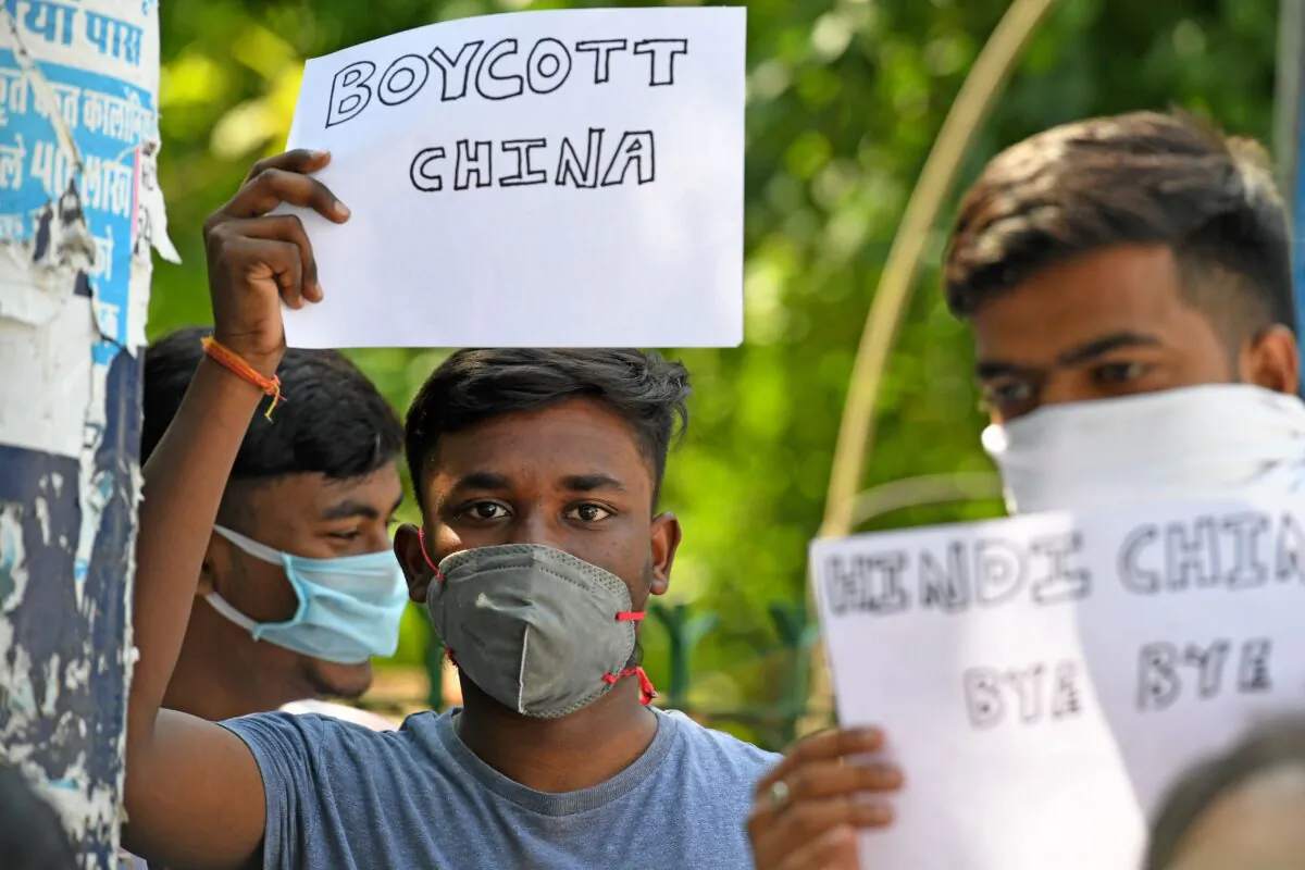 Protesters display placards urging citizens to boycott Chinese goods during a demonstration in New Delhi, India, on June 18, 2020. (Prakash Singh/AFP via Getty Images)