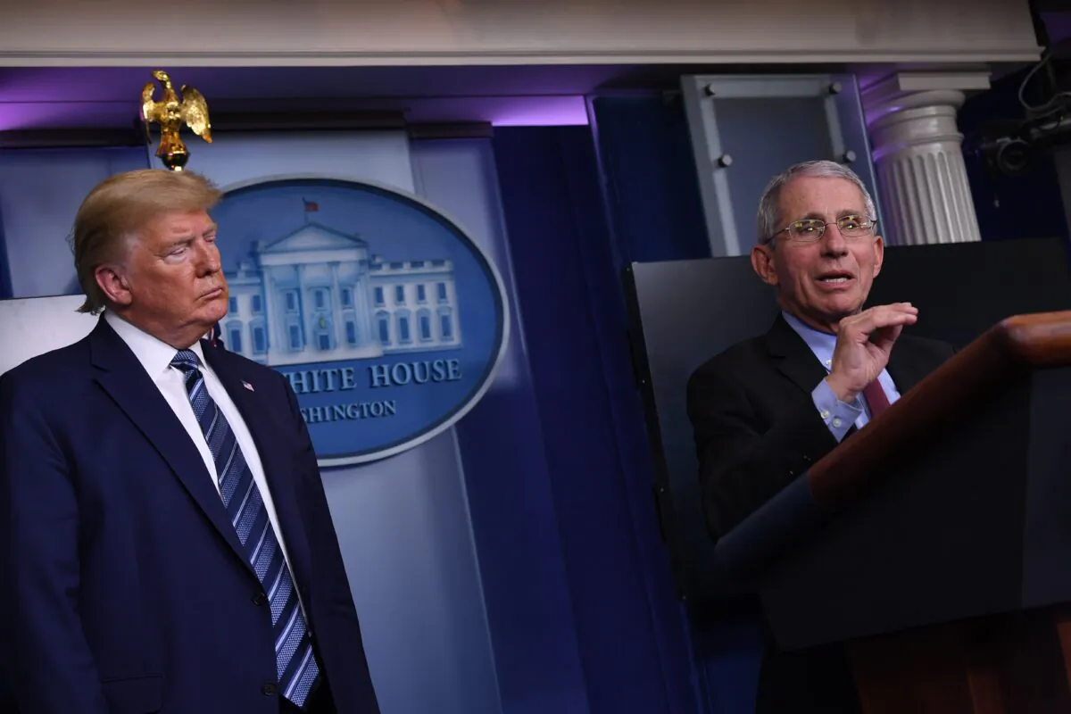 Dr. Anthony Fauci (R) speaks while President Donald Trump listens, during a White House Coronavirus Task Force briefing at the White House in Washington on April 5, 2020. (Eric Baradat/AFP via Getty Images)