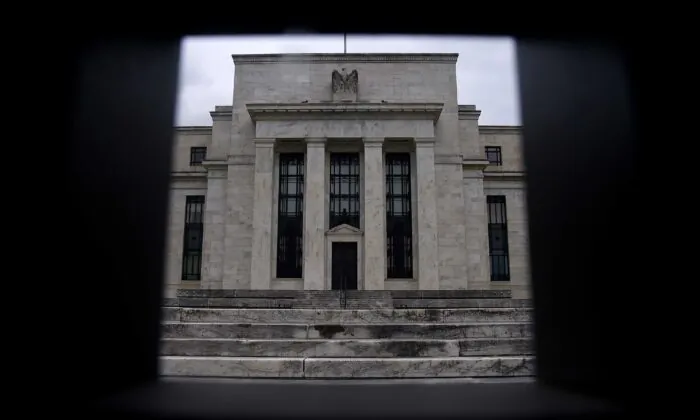 The Federal Reserve Building is seen through a fence in Washington on June 17, 2020. (Olivier Douliery/AFP via Getty Images)