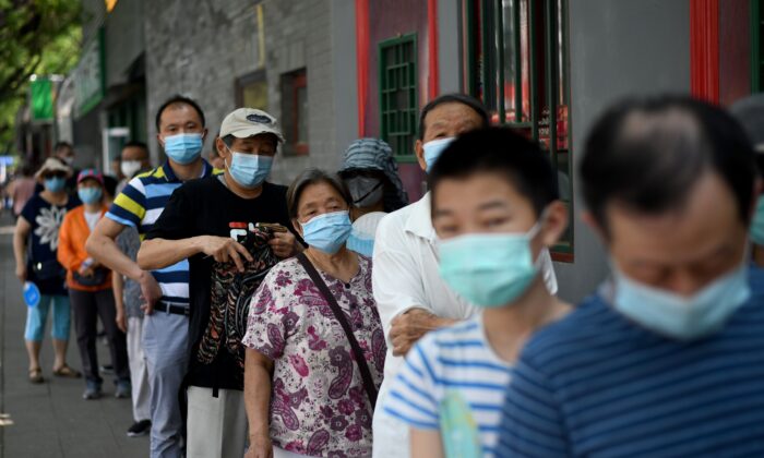 People line up to take a swab test during mass testing for the COVID-19 coronavirus in Beijing, China on June 21, 2020. (NOEL CELIS/AFP via Getty Images)