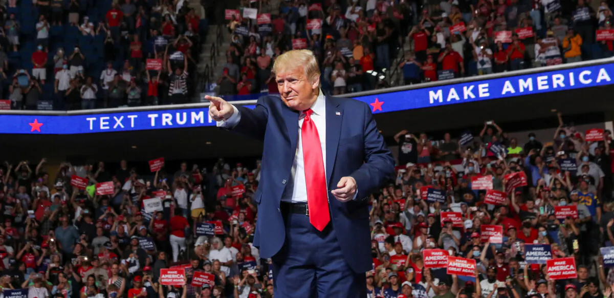 President Donald Trump points at the crowd as he enters his first re-election campaign rally in several months in the midst of the CCP virus outbreak, at the BOK Center in Tulsa, Okla., on June 20, 2020. (Leah Millis/Reuters)