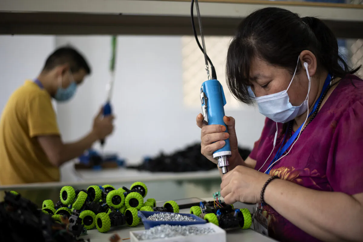 Workers assembling toys at the Mendiss toy factory in Shantou, Guangdong Province, on May 20, 2020. Cancelled shipments, returned goods, and a dearth of new orders have left Chinese exporters in crisis as the coronavirus hits its trading partners worldwide. (Noel Celis/AFP via Getty Images)