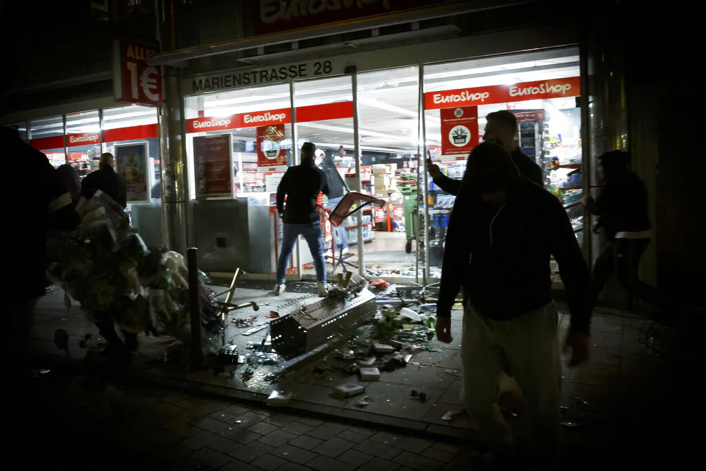 People broke into a shop on Marienstrasse in Stuttgart, Germany, Sunday, June 21, 2020. (Julian Rettig/dpa via AP)